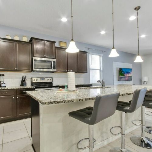 Fully equipped kitchen with extra seating around the island.