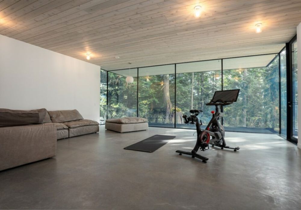 This is a quiet, separate space, just off the main living area with a Peloton spin bike, yoga mat and extra seating all available for you during your stay.