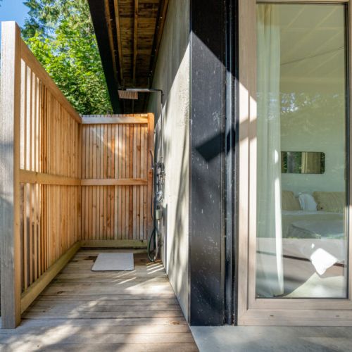 The home is equipped with an outdoor shower, right outside of the primary bedroom.