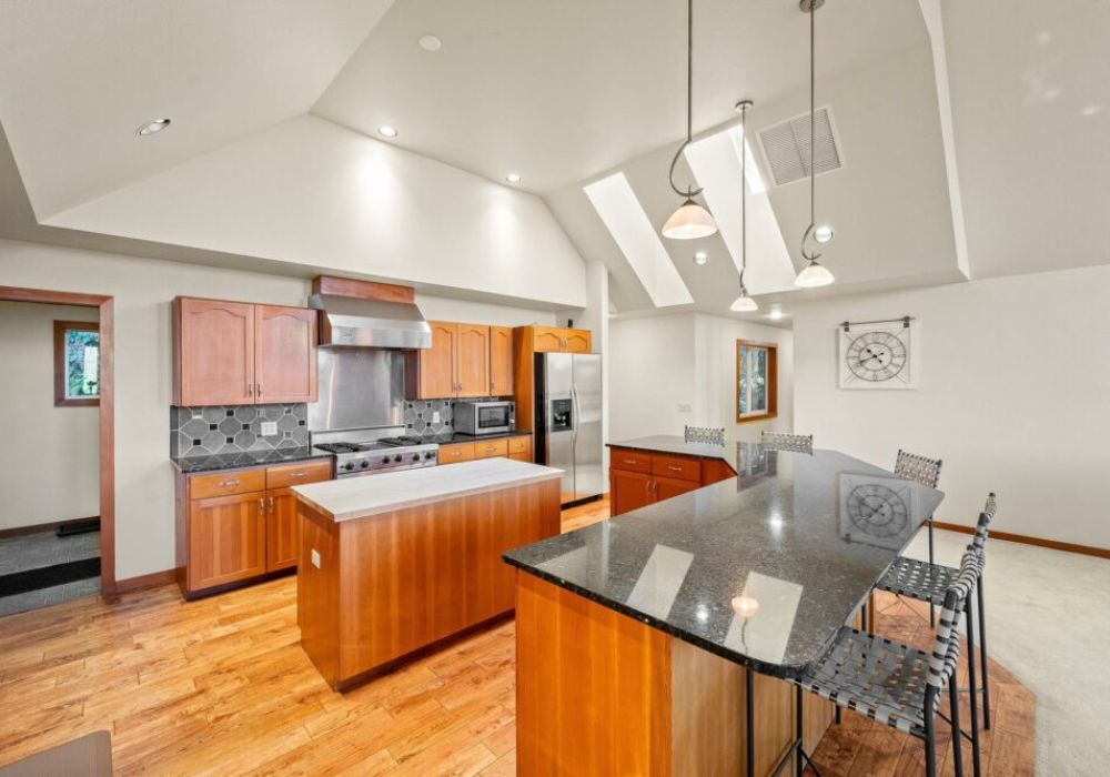 Large, gourmet kitchen with island and breakfast bar seating.