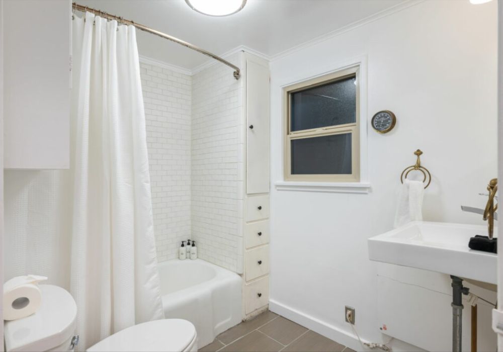 Remodeled bathroom with tub / shower.