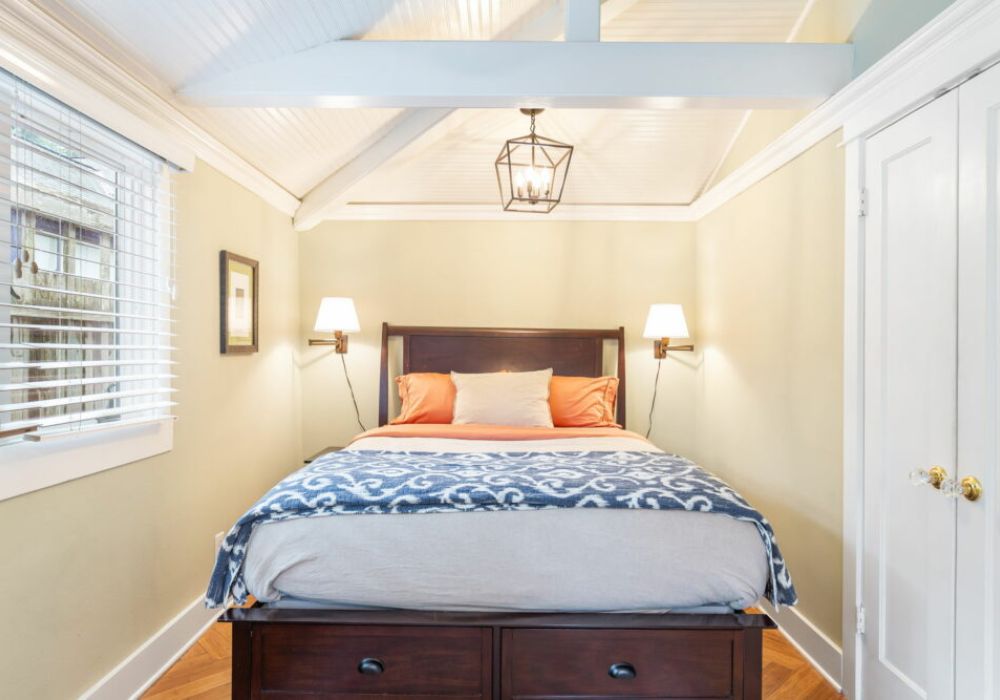 The primary bedroom features a Queen bed and access to the backyard.