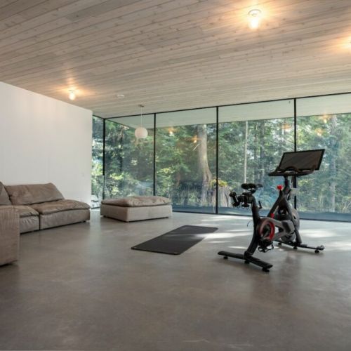 This is a quiet, separate space, just off the main living area with a Peloton spin bike, yoga mat and extra seating all available for you during your stay.