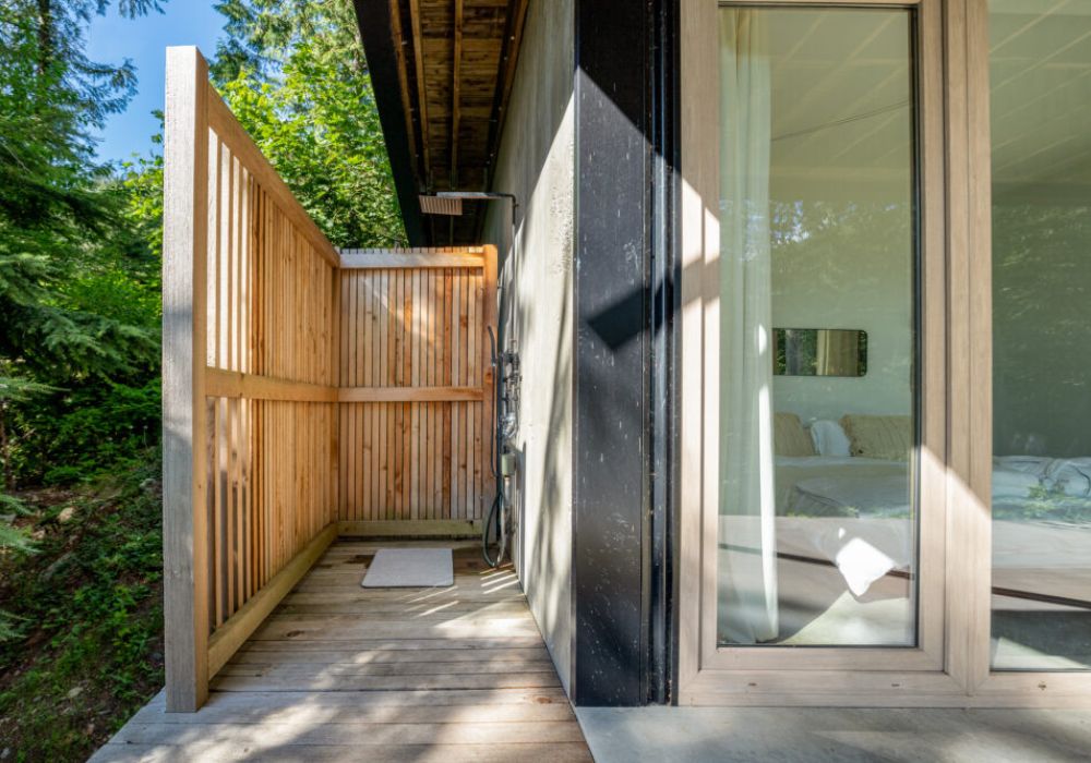 The home is equipped with an outdoor shower, right outside of the primary bedroom.